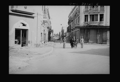 Sousse, Tunisia. Archbishop Spellman walking with American officers through the streets of Sousse