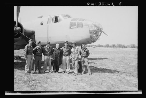 Archbishop Spellman of New York posing with the crew of a B-25 medium bomber at the farthest advanced U.S. bomber base in Tunisia