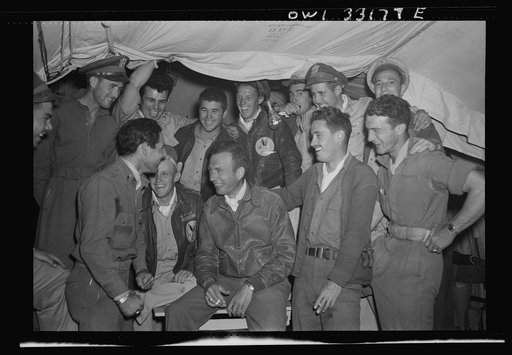 Untitled photo, possibly related to: Lieutenant Colonel William K. McKnown, of Lawrence, Kansas, commander of the 314th Squadron of the 57th Fighter Group (center, wearing leather jacket) talking to his two aces, who each shot down five enemy planes over the Sicilian straits on April 18th; Lieutenan