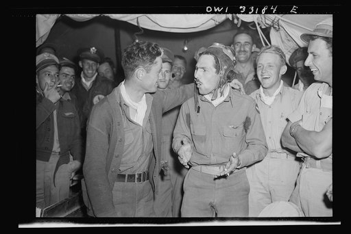 Richard E. Duffey, twenty-four, of Walled Lake, Michigan, explaining his latest victory to Lieutenant MacArthur Powers, twenty-seven, of Inwood, New York, somewhere in Tunisia