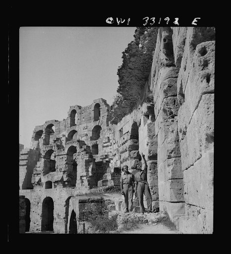 American troops of the 57th Fighter Group sightseeing among Roman ruins in Tunisia