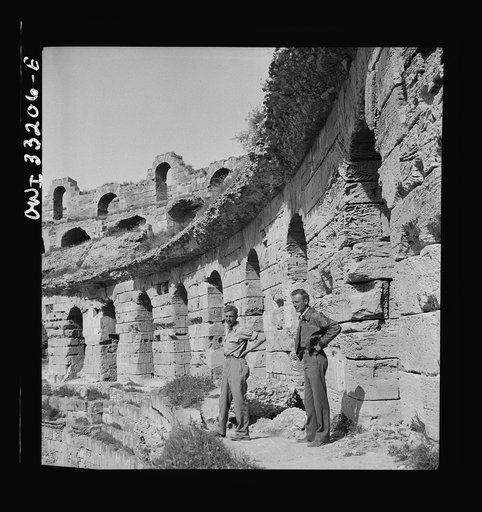 American troops of the 57th Fighter Group sightseeing among Roman ruins in Tunisia