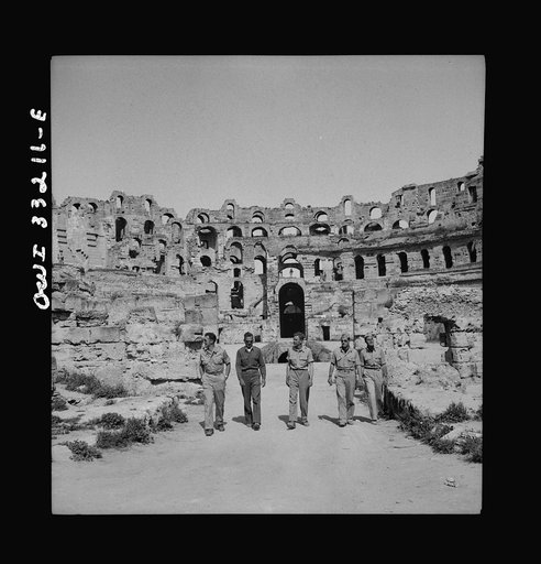 American troops of the 57th Fighter Group sightseeing among Roman ruins in Tunisia