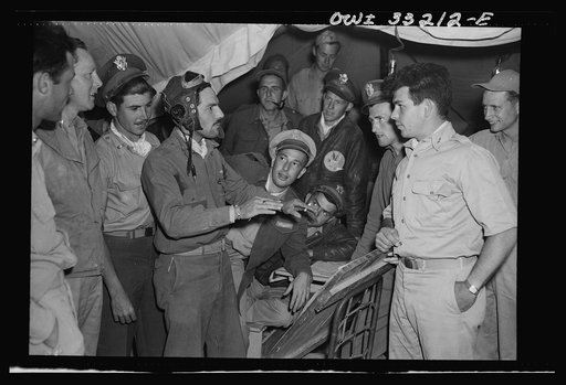 Lieutenant Richard E. Duffey, twenty-four, of Walled Lake, Michigan, giving an account at the 57th Fighter Group base in Tunisia of the actions of his group during the air battle of April 18, in which four squadrons of the 57th Fighter Group destroyed seventy-four enemy planes. Lieutenant Duffey des