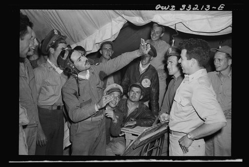 Lieutenant Richard E. Duffey, twenty-four, of Walled Lake, Michigan, giving an account at the 57th Fighter Group base in Tunisia of the actions of his group during the air battle of April 18, in which four squadrons of the 57th Fighter Group destroyed seventy-four enemy planes. Lieutenant Duffey des