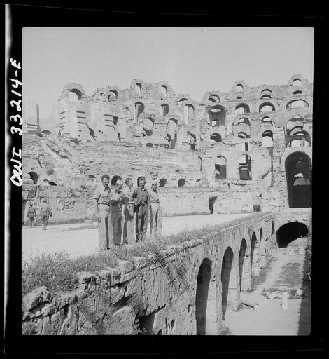 American troops of the 57th Fighter group sightseeing among Roman ruins in Tunisia