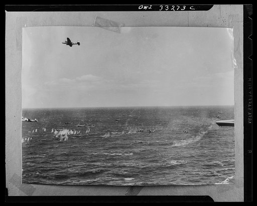 A formation of U.S. Army Air Forces B-25 Mitchell bombers and an escort of P-28 Lightnings engaged an Axis air convoy of thirty-five planes over the Sicilian Straits recently and shot down twenty- five of them. American plane at the extreme left flying low has just completed attack action while anot
