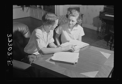 Keysville, Virginia. One of the teachers in the school helping her brother, a pupil, with his studies. He and his brother run a garage at night. All teachers in the school are local