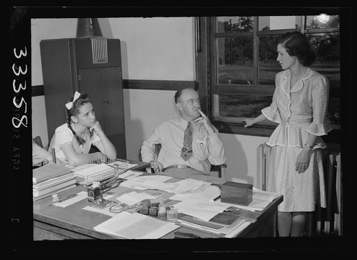 Untitled photo, possibly related to: Keysville, Virginia. Randolph Henry High School. Mr. J. M. Garber, principal, working with two students on their next semester's schedules