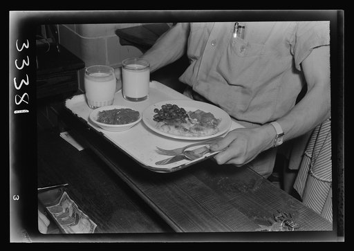 Keysville, Virginia. Randolph Henry High School. Cafeteria. Students don't have much money so they bring produce from farms for which they receive tickets. Lunches cost about fifteen cents. Typical lunch for fifteen cents: candied yams, macaroni and cheese, fruit salad, deviled eggs, dessert and mil