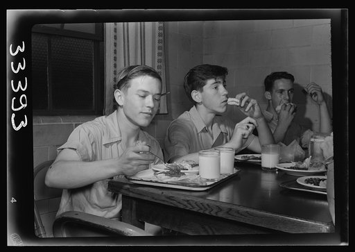 Keysville, Virginia. Randolph Henry High School. Cafeteria. Students don't have much money so they bring produce from farms for which they receive tickets. Lunches cost about fifteen cents. Typical lunch for fifteen cents: candied yams, macaroni and cheese, fruit salad, deviled eggs, dessert and mil