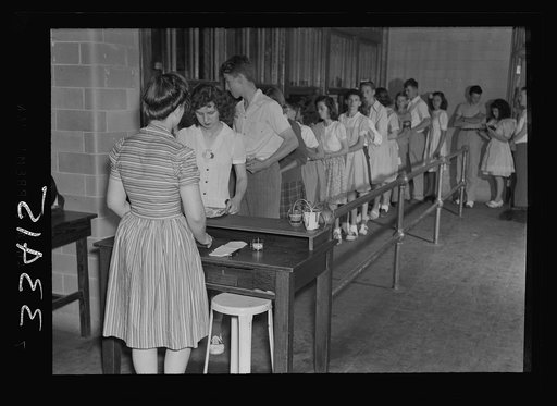 Keysville, Virginia. Randolph Henry High School. Cafeteria. Students don't have much money so they bring produce from home for which they receive tickets. Lunches cost about fifteen cents. Typical lunch for fifteen cents: candied yams, macaroni and cheese, fruit salad, deviled eggs, dessert and milk