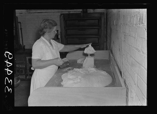 Untitled photo, possibly related to: Keysville, Virginia. Baking bread in central bakery. Seventy-five loaves are baked here each day and sent to schools via school buses