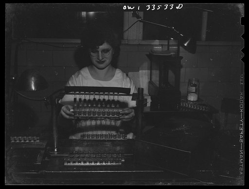 Untitled photo, possibly related to: Parke, Davis and Company, manufacturing chemists, Detroit, Michigan. Automatically filling ampoules with medicinal solution