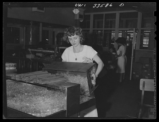 Parke, Davis and Company, manufacturing chemists, Detroit, Michigan. Girl with a tray of empty ampoules