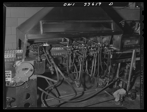 Parke, Davis and Company, manufacturing chemists, Detroit, Michigan. A machine through which filled glass ampoules are passed for automatic sealing