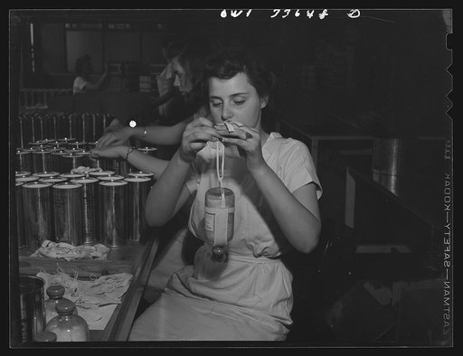Parke, Davis and Company, manufacturing chemists, Detroit, Michigan. Attaching the sling for suspending flasks of blood plasma