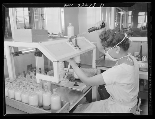 Parke, Davis and Company, manufacturing chemists, Detroit, Michigan. Capping bottles of blood plasma