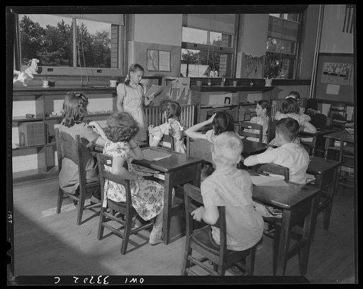 Schenectady, New York. A class at the Elmer Avenue Elementary School. After the children have written stories, they stand up in front of the class, one by one, and read their stories for class discussion
