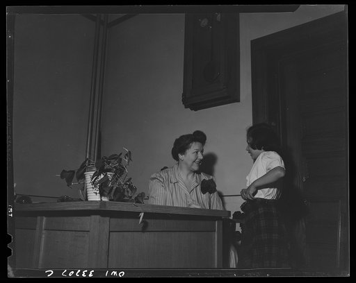 Untitled photo, possibly related to: Schenectady, New York. A pupil at the Elmer Avenue Elementary School getting a note from the school principal to the teacher, allowing her to get into class late