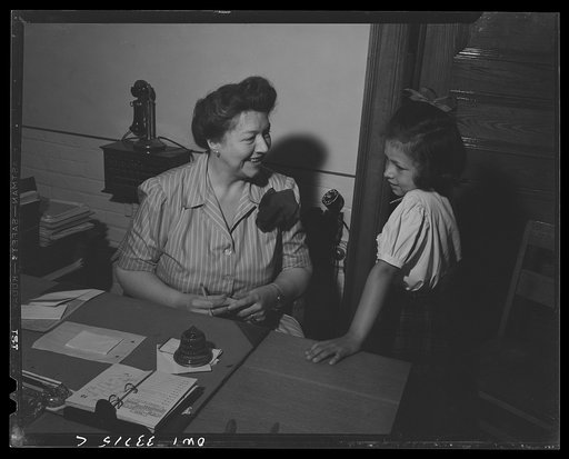 Schenectady, New York. A pupil at the Elmer Avenue Elementary School getting a note from the school principal to the teacher, allowing her to get into class late