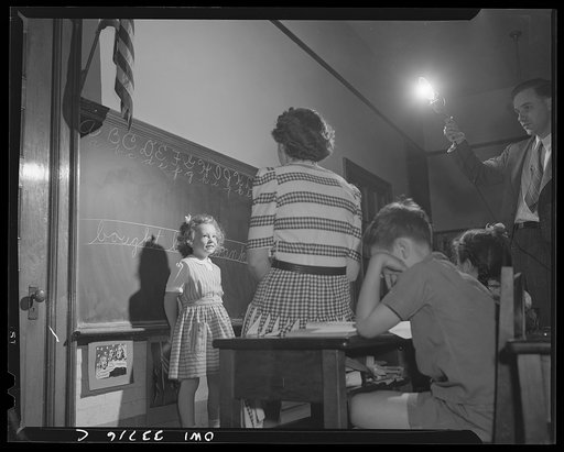 Schenectady, New York. After the child at the Elmer Avenue Elementary School has finished her written spelling examination on the blackboard, she takes her oral examination