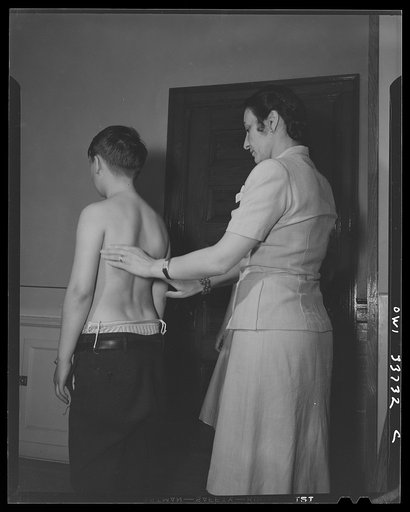 Schenectady, New York. This boy, a pupil at the Elmer Avenue Elementary School, has been taking exercise in corrective classes. He is being checked up to see how his back is progressing