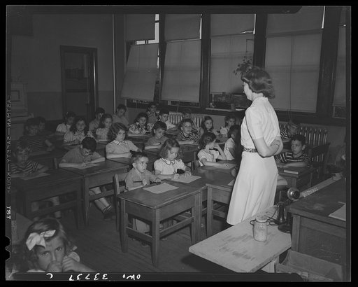 Schenectady, New York. Little Philip, eyes raised, is deaf. Here he is taking a spelling test with his class at the Pleasant Valley School. Philip is reading his teacher's lips