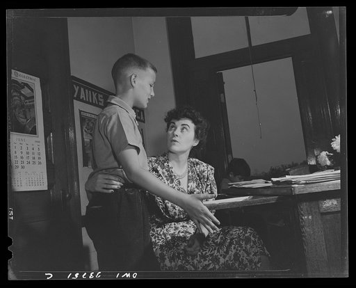 Schenectady, New York. A pupil at the Elmer Avenue Elementary School talking over his report card with his teacher
