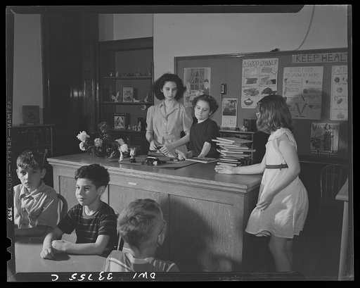 Schenectady, New York. Checking out a book from the school library at the Elmer Avenue Elementary School