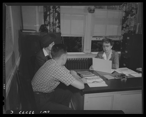 Schenectady, New York. School counselor at the Onieda School helping a mother and her child decide his career possibilities