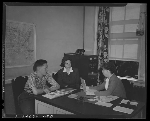Untitled photo, possibly related to: Schenectady, New York. School counselor at the Onieda School helping a mother and her child decide his career possibilities