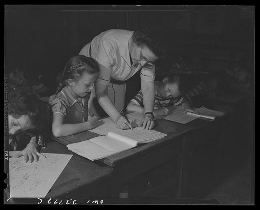 Schenectady, New York. If a child at the Elmer Avenue Elementary School comes across a word she would like to use in writing a story but cannot spell the teacher comes and letters it in the child's own private speller