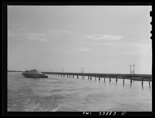 Freeport Sulphur Company, Port Sulphur, Louisiana. Bargeload of sulphur going down the channel