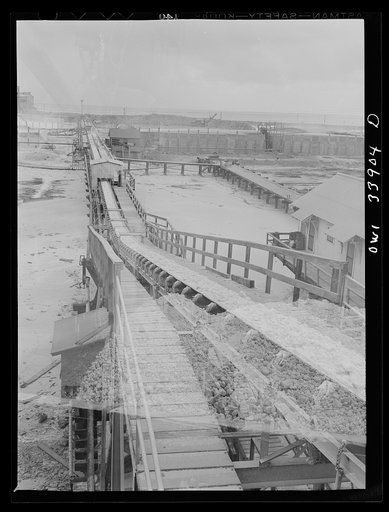 Untitled photo, possibly related to: Freeport Sulphur Company, Grand Ecaille, Louisiana. Conveyor belt which carries sulphur from vats to hopper where it is loaded on the barges