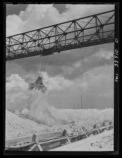 Freeport Sulphur Company, Port Sulphur, Louisiana. Unloading sulphur from a barge to storage vats