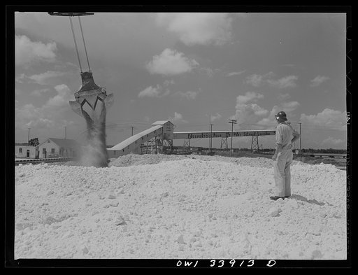 Freeport Sulphur Company, Port Sulphur, Louisiana. Unloading sulphur from a barge to storage vats