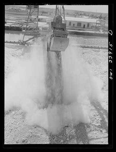 Freeport Sulphur Company, Port Sulphur, Louisiana. Unloading sulphur from a barge to storage vats