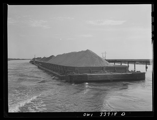 Freeport Sulphur Company, Port Sulphur, Louisiana. Bargeload of sulphur going down the channel