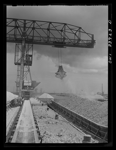 Freeport Sulphur Company, Port Sulphur, Louisiana. Unloading sulphur from a barge to storage vats