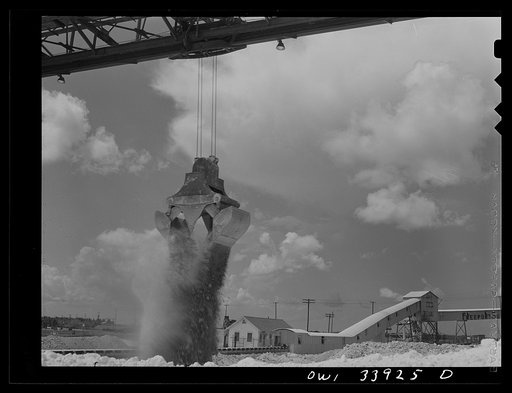 Freeport Sulphur Company, Port Sulphur, Louisiana. Unloading sulphur from a barge to storage vats