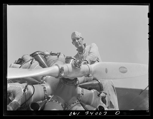 Corpus Christi, Texas. Sergeant George Caveres, a member of the Civil Air Patrol, working on the motor of a plane. Sergeant Caveres formerly operated a garage in Corpus Christi