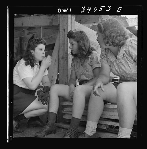Untitled photo, possibly related to: Turkey Pond, near Concord, New Hampshire. Women workers employed by U.S. Department of Agriculture timber salvage sawmill. A break in the work comes every once in a while when equipment needs minor repairs or adjustments. Left to right, Barbara and Norma Webber, 