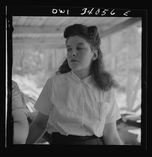 Untitled photo, possibly related to: Turkey Pond, near Concord, New Hampshire. Women workers employed by a U.S. Department of Agriculture timber salvage sawmill. Barbara Webber, twenty-one year old edger, finds her job harder physically than working in a laundry, but she likes it better because it i