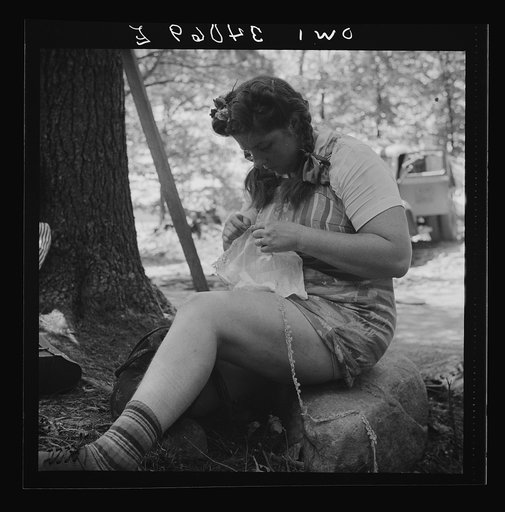 Untitled photo, possibly related to: Turkey Pond, near Concord, New Hampshire. Women workers employed by a U.S. Department of Agriculture timber salvage sawmill. Mrs. Violet Storey, "take-away," brought her sewing along to make full use of her lunch hour. She is a farmer's wife and the mother of six