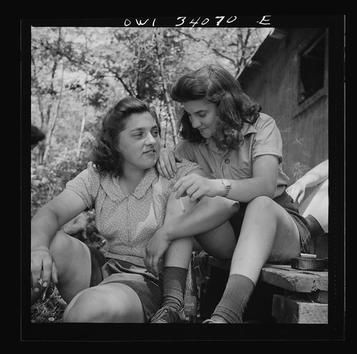 Untitled photo, possibly related to: Turkey Pond, near Concord, New Hampshire. Women workers employed by U.S. Department of Agriculture timber salvage sawmill. Ruth DeRoche and Norma Webber, eighteen year old "pit-women," relaxing after lunch
