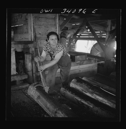 Turkey Pond, near Concord, New Hampshire. Women workers employed by a U.S. Department of Agriculture timber salvage sawmill. Mrs. Dorothy De Greenia, slip woman, rolling the logs off the slip to the rack which holds them until the sawer is ready for them