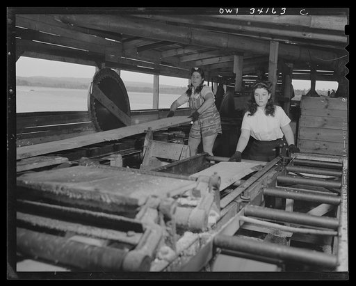 Turkey Pond, near Concord, New Hampshire. Women workers employed by a U.S. Department of Agriculture timber salvage sawmill.  Mrs. Violet Storey, "take away," lifting one end of a rough board to swing it from the conveyor to the balance where Barbara Webber, right, will take it and put it through th