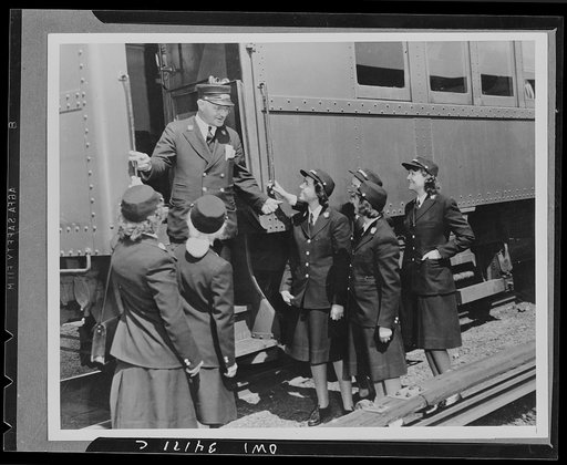 Conductor Ray Tutle, veteran conductor, instructing women trainmen, a group of the first women employed by the Long Island Railroad to replace trainmen now serving in the nation's armed forces