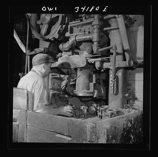New Britain, Connecticut A core blowing machine. Sand is blown into the core box as it travels away from the machine on a conveyor